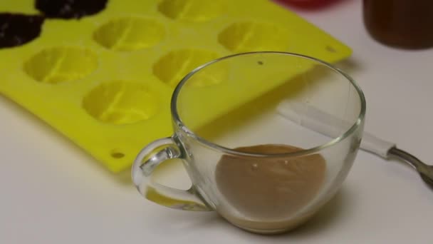 Kadın siyah sıvı çikolatayı silikon şeklinde fırçaladı. Jöleli şekerlerin hazırlanması için.. — Stok video