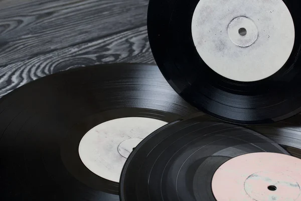 Viejos discos de vinilo. Sobre el fondo de tablas de pino cepillado pintadas en blanco y negro . — Foto de Stock