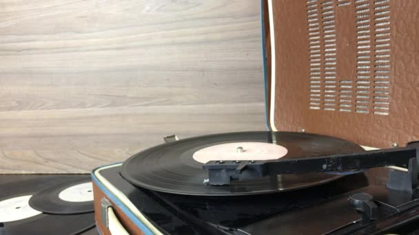 Starý gramofon s gramofonovou deskou. Přehrávání probíhá. Zvedací jehla je namontována na koleji otočného otočného stolu. — Stock video