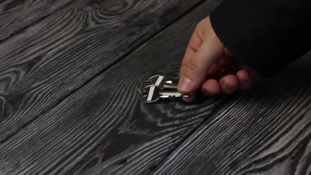 Bir adam masanın yüzeyine bir sürü anahtar bırakıyor. Bir başkası alır. Ayrıntılı olarak alındı — Stok video