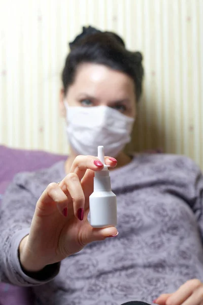 Woman Medical Mask Sits Bed Holds Nasal Spray Her Hands — Stock Photo, Image