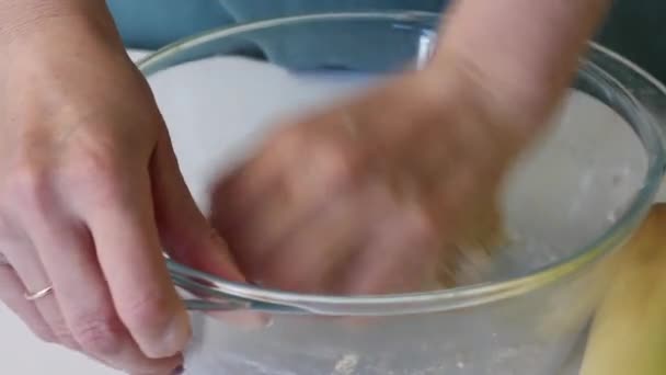 Una mujer amasa un trozo de masa para pasteles frescos. Arrodillándose con las manos en un recipiente de vidrio. Prepara pan sin levadura . — Vídeos de Stock