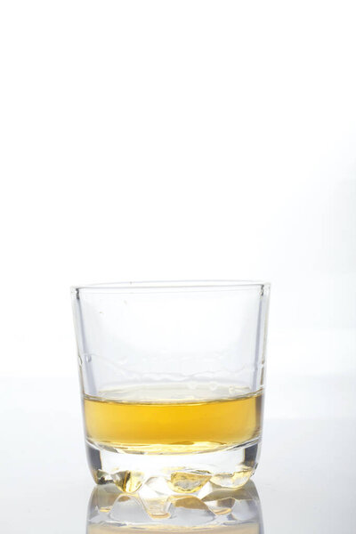 Glass transparent glass with strong alcohol. On a white background.