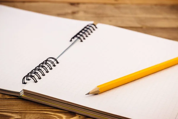 tahta bir masanın üzerinde yatan yer imleri ile üstünde defter kalem