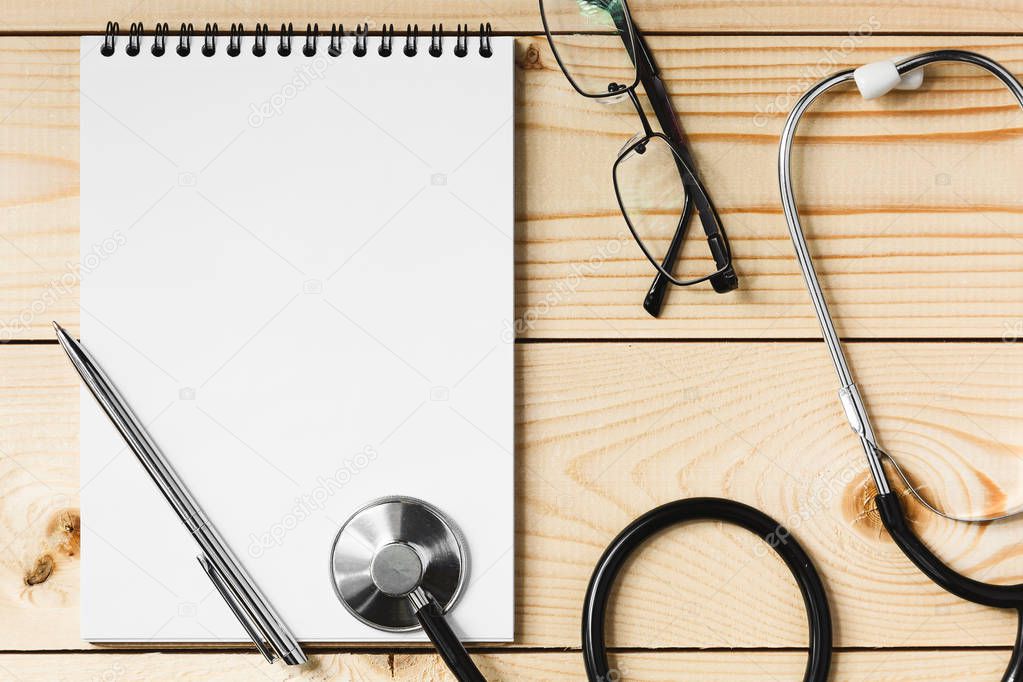 Stethoscope on a wooden table, concept medicine