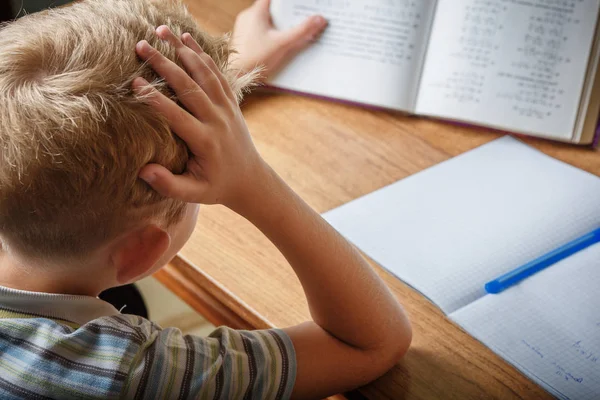 Çocuk evde ödevini yapıyor.