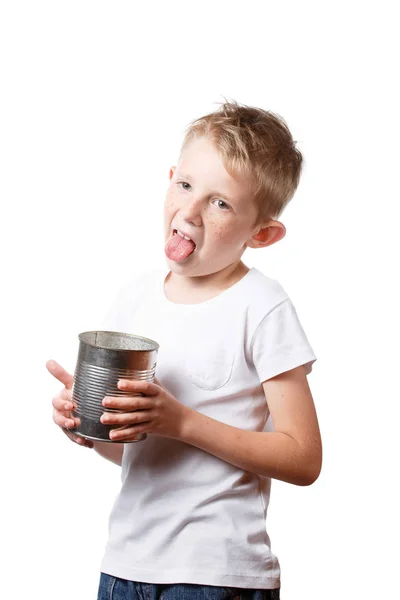 Child eats from a tin can, starving boy looking to eat — Stock Photo, Image