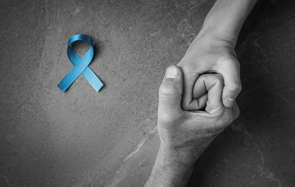 Hands holding blue ribbon flat lay — Stock Photo, Image
