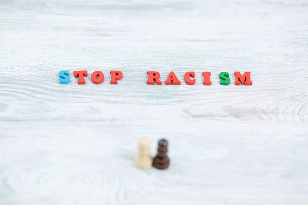 No to racism in colored letters on gray background — Stock Photo, Image