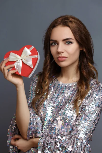 girl in shiny dress with gift box