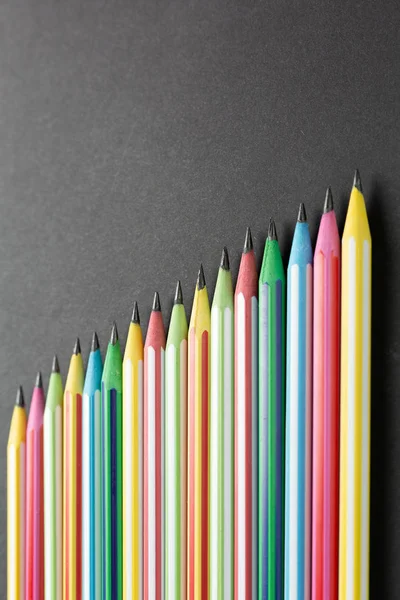 Colored pencils lined up in row top view. — 스톡 사진