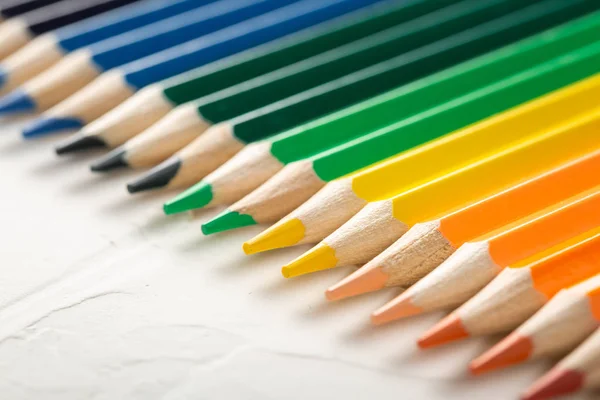 Colored pencils on white close-up in macro — Stock Photo, Image