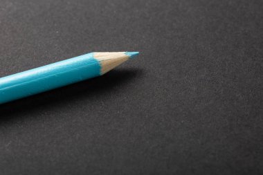 blue pencil on a gray background top view.