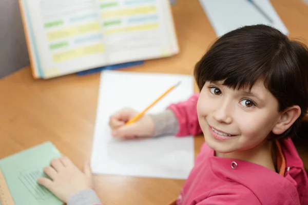 Cute asian girl doing homework.