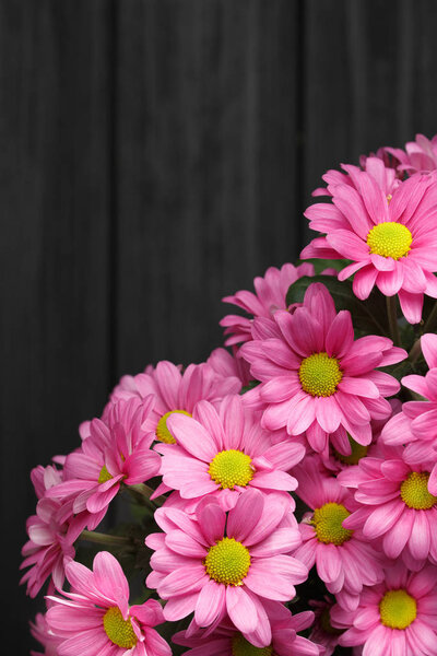 Pink flowers bouquet,over wood background.