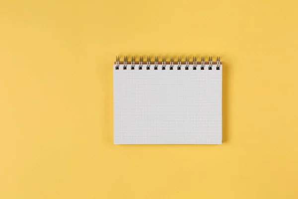 Notebook on a yellow background top view — Stock Photo, Image