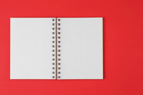 Open notebook on red background — 스톡 사진