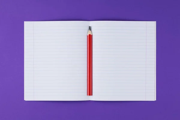 School notebook with pencil on violet background — Stock Photo, Image