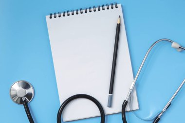 Stethoscope, notebook, glasses and pen