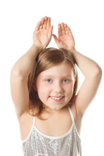 Girl on a white background makes a rabbit ears