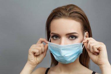 Pretty woman put on medical mask