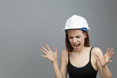 Cute woman in a white construction helmet
