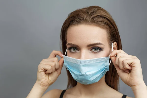 Pretty woman put on medical mask
