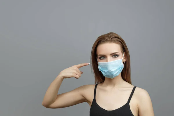 Pretty woman with medical mask on — 스톡 사진