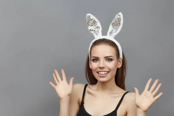 Pretty smiling woman with rabbit ears — Stock Photo, Image