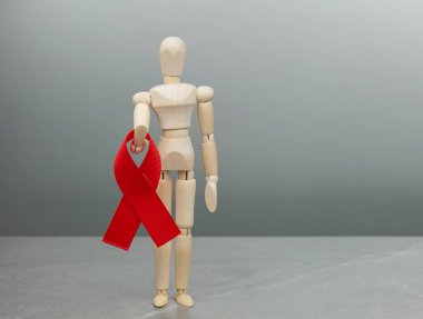 Tahta figür ve HIV kırmızı kurdelesi
