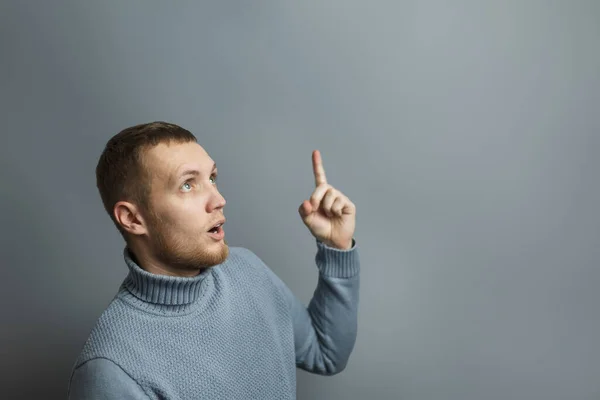 Handsome man shows thumb up in surprise — Stockfoto