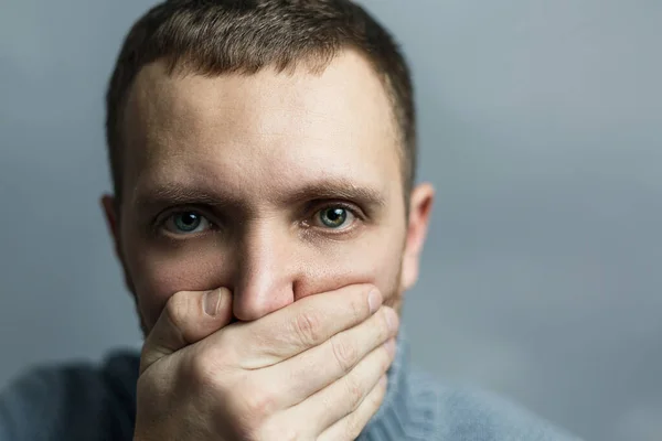 Guy covered mouth with his hand