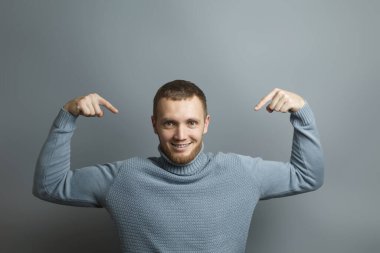 Young man pointing fingers on himself