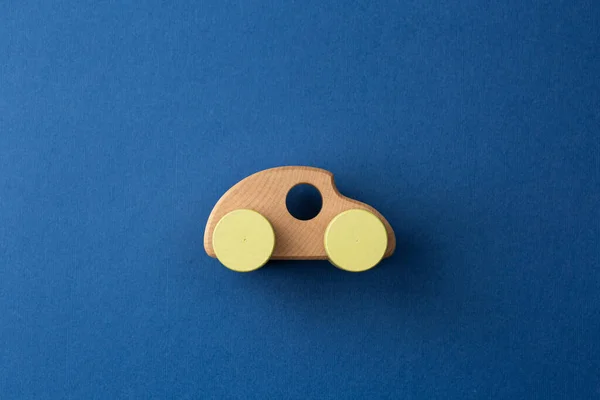 Wooden car on a blue isolated background.