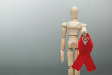 Tahta figür ve HIV kırmızı kurdelesi