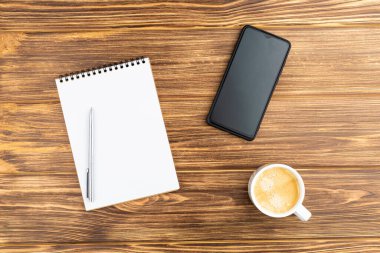 Akıllı telefon ve kahve fincanlı defter..