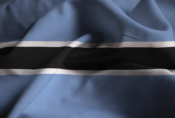 Primer plano de la bandera de Botswana con volantes, bandera de Botswana soplando en el viento — Foto de Stock