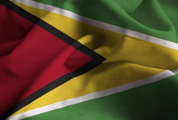 Primer plano de la bandera de Guyana con volantes, bandera de Guyana soplando en el viento — Foto de Stock