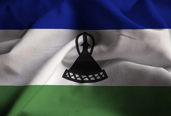 Primer plano de la bandera de Lesotho con volantes, bandera de Lesotho soplando en el viento — Foto de Stock