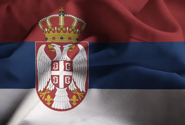 皱的塞尔维亚国旗，塞尔维亚国旗在风中吹的特写 — 图库照片