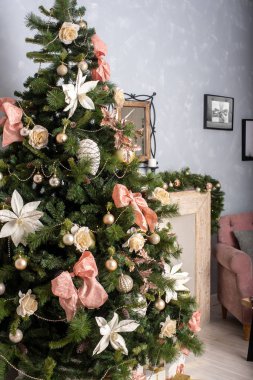a large Christmas tree decorated against the backdrop of a home interior