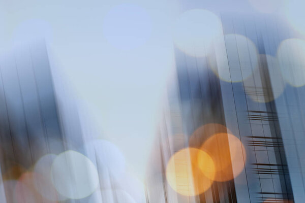 Abstract business modern city urban futuristic architecture background. Real estate concept, motion blur, reflection in glass of high rise skyscraper facade, toned blue picture with bokeh