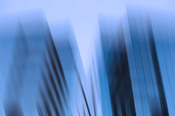 Abstract business modern city urban futuristic architecture background, motion blur, reflection in glass of high rise skyscraper facade, toned blue picture with bokeh. Real estate concept — Stock Photo, Image
