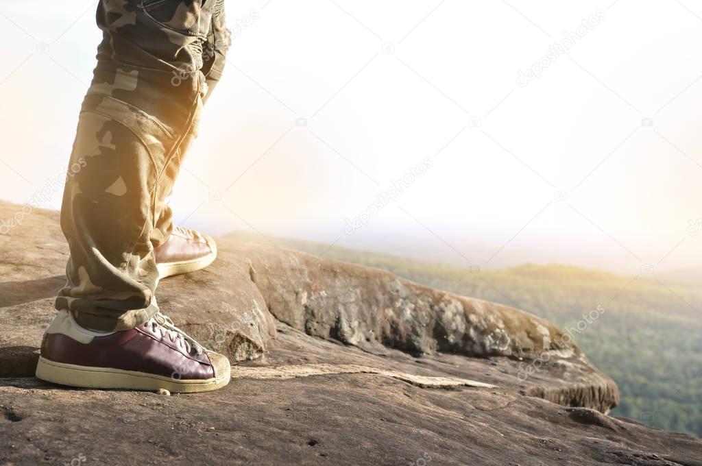 Close up of man standing on top of a mountain.