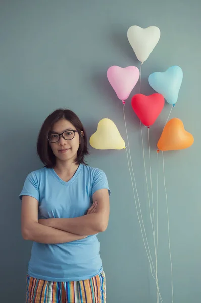 Mujer y globos multicolores en forma de corazón — Foto de Stock