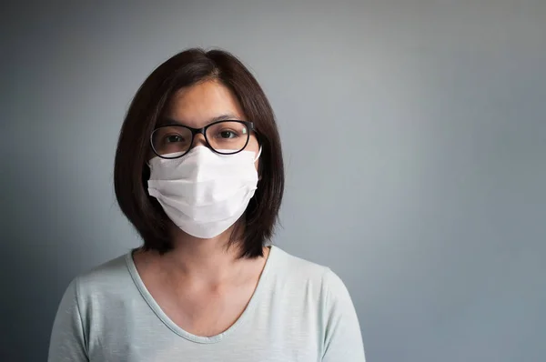 Asian glasses woman wear medical mask with copy space.