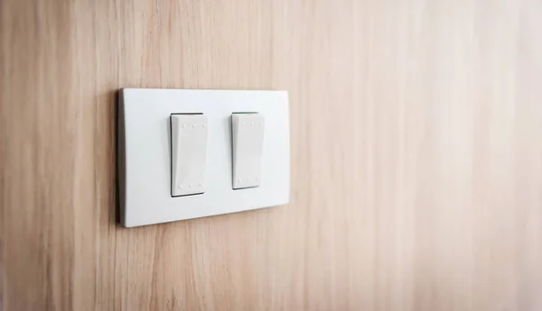 Close up grey light switch on wooden background. Copy space. — Stock Photo, Image