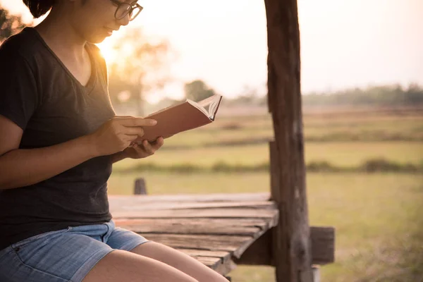 Asian girl reading a book on countryside background. — Stock Photo, Image