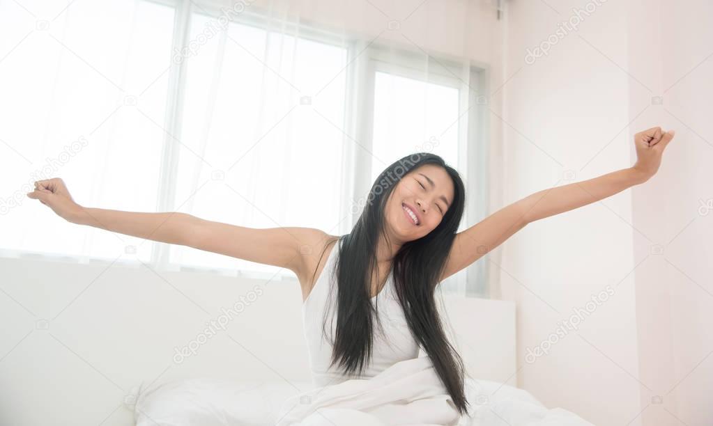 Beautiful Asian woman waking up in the morning.