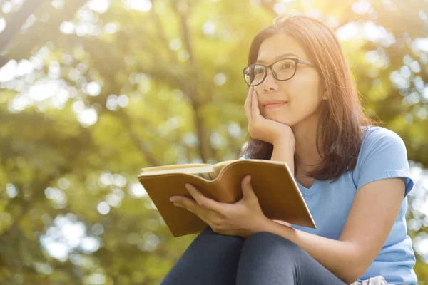 Asian woman in Glasses holding a book. — Stock Photo, Image